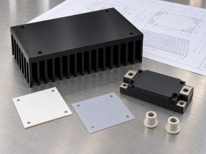 anodize heat sink for insulation: separate heat sink, device housing, white and gray sheets, and white shouldered bushings