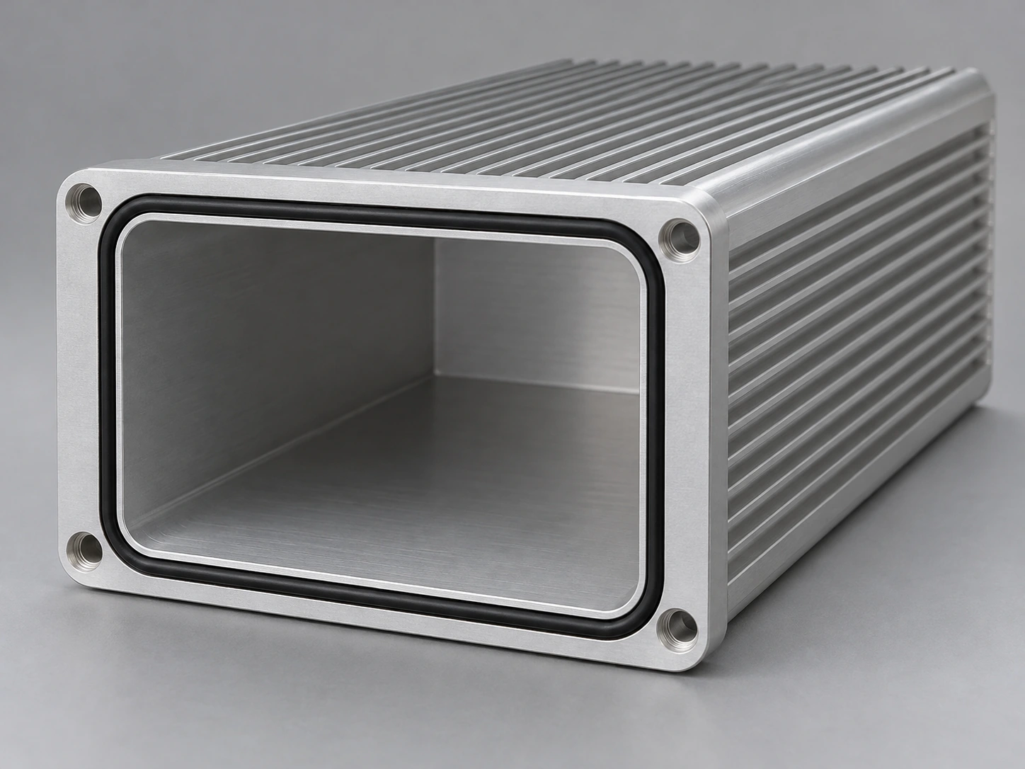 Open machined aluminum enclosure end face with continuous gasket groove and elastomer seal