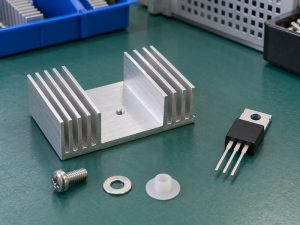 Heat sink for voltage regulator cooling beside a separate regulator package
