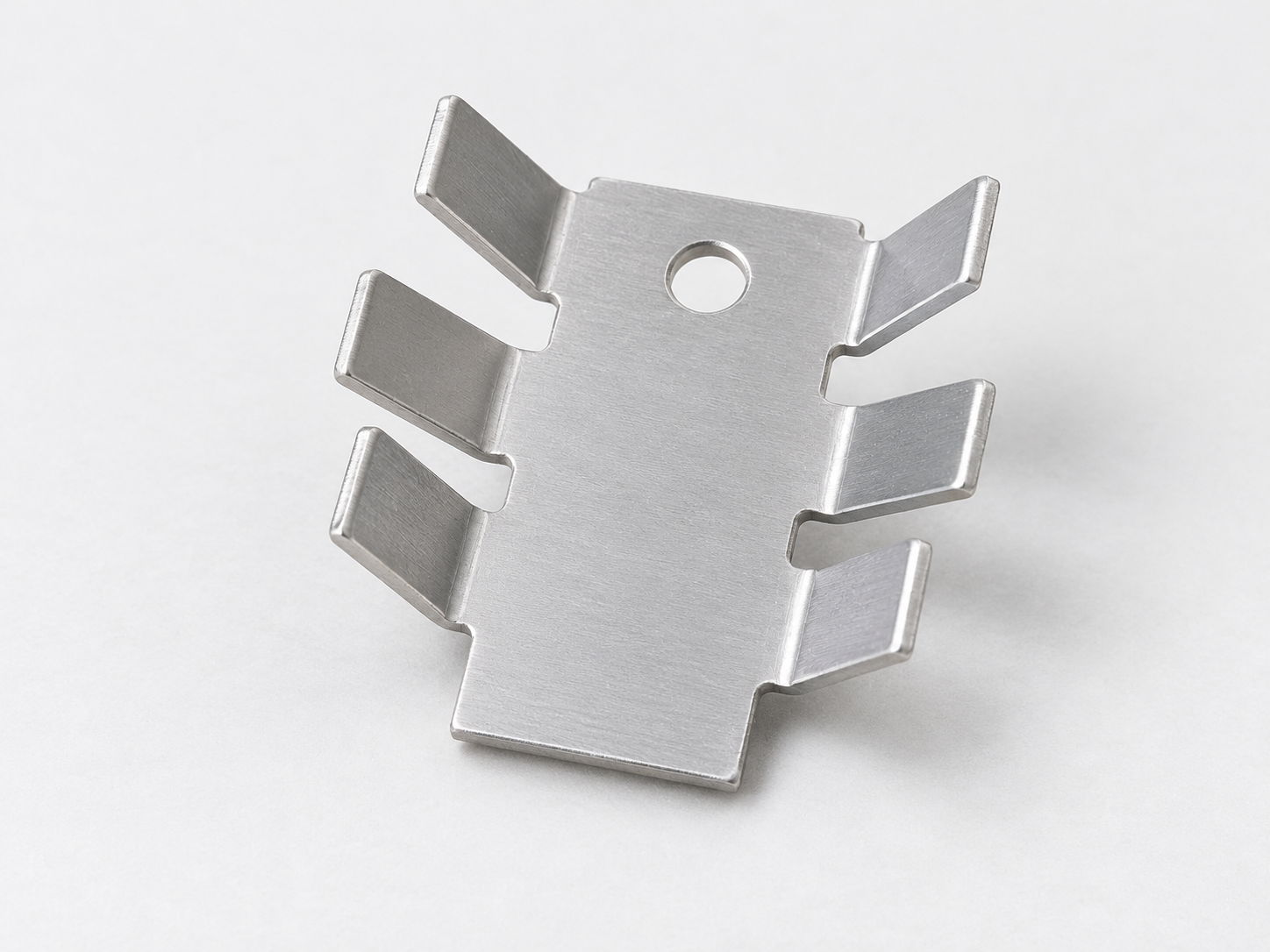 Natural aluminum stamped heat sink with six separated bent cooling fingers and a central mounting hole.