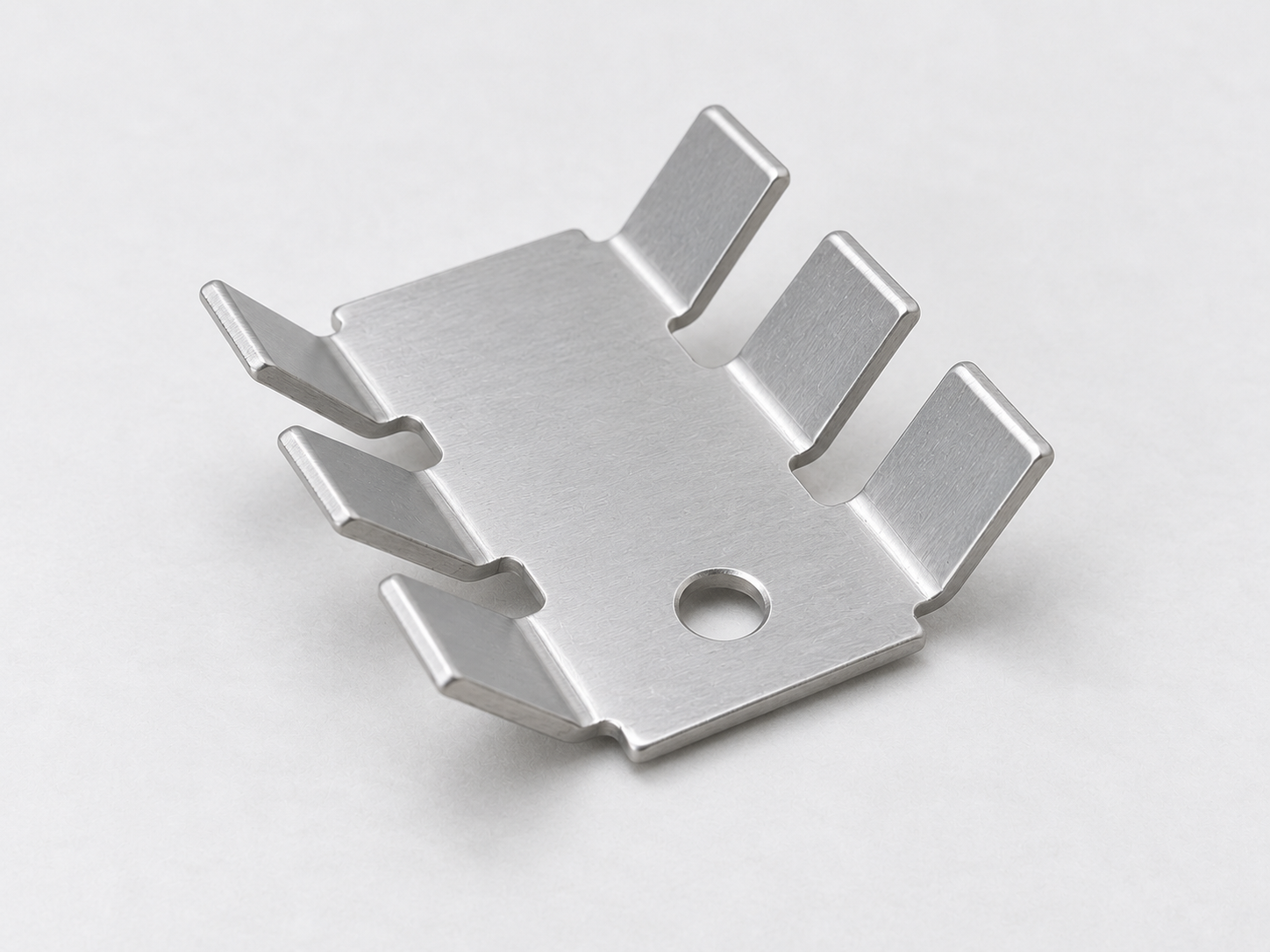 Punched gaps, smooth bend radii and continuous sheet construction on a six-finger stamped aluminum heat sink.