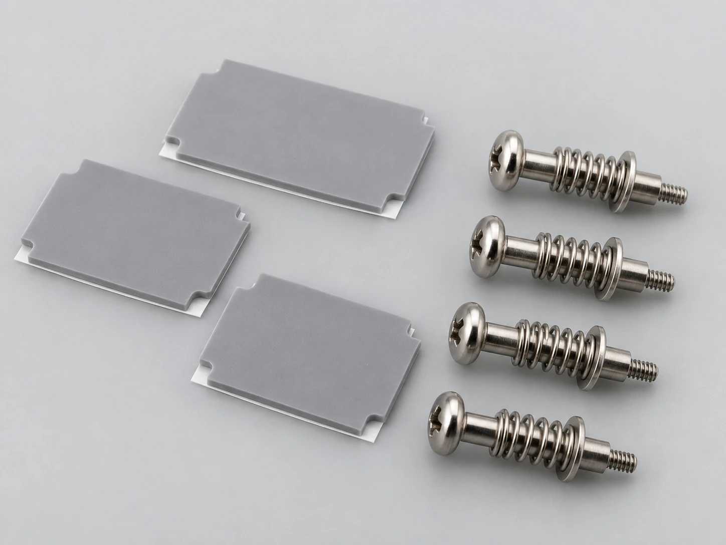 Precision thermal interface material pads and four spring-loaded mounting screws