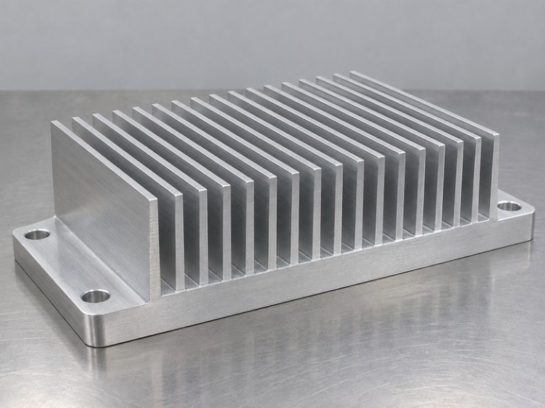 Structural integrity aluminum heat sink sample with a thick base and broad mounting ears