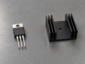 Voltage regulator heat sink beside a separate three-pin TO-220 package