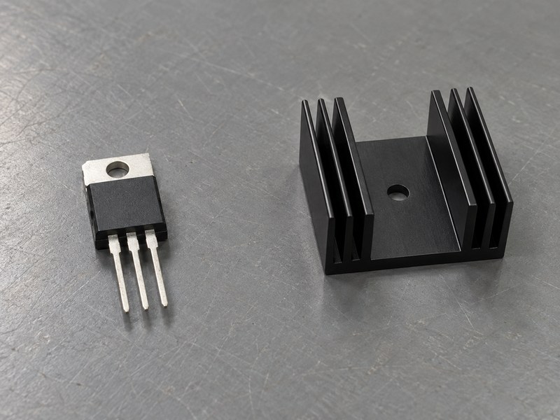 Voltage regulator heat sink beside a separate three-pin TO-220 package
